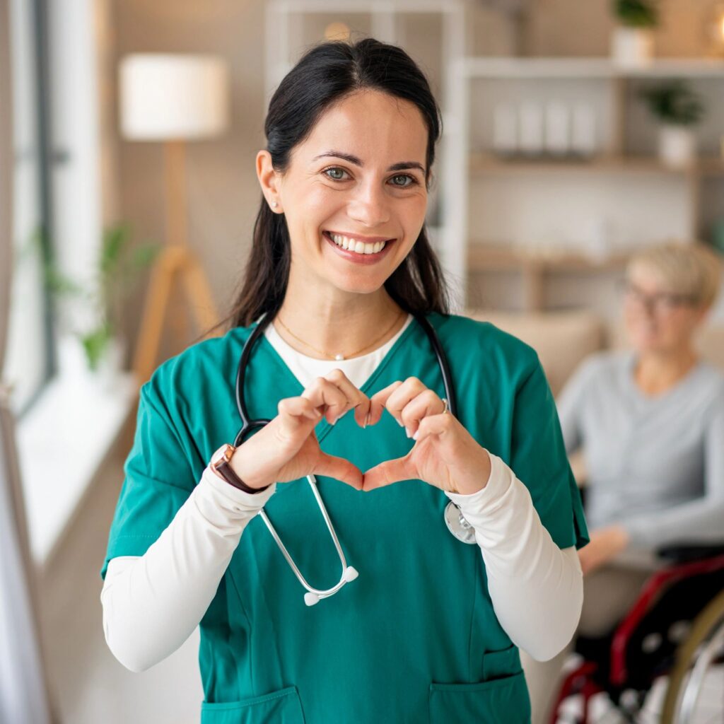 Female nurse showing heart sign providing care